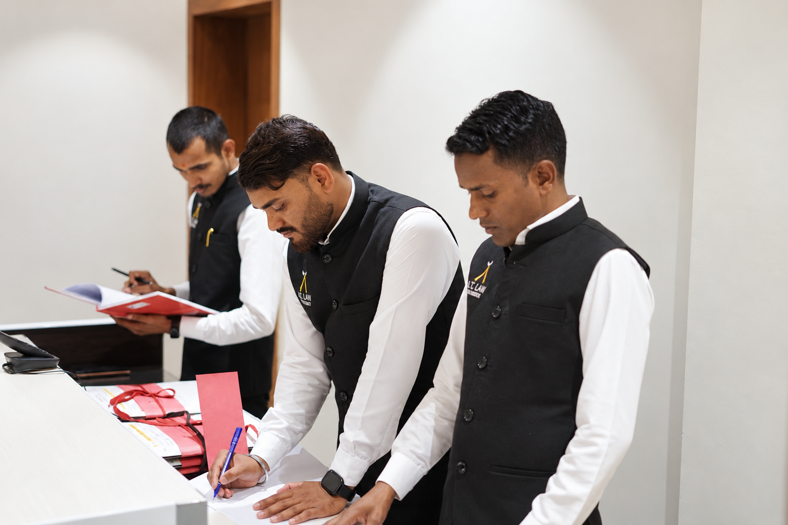 A.T. Law Chambers support staff preparing and organising office paperwork